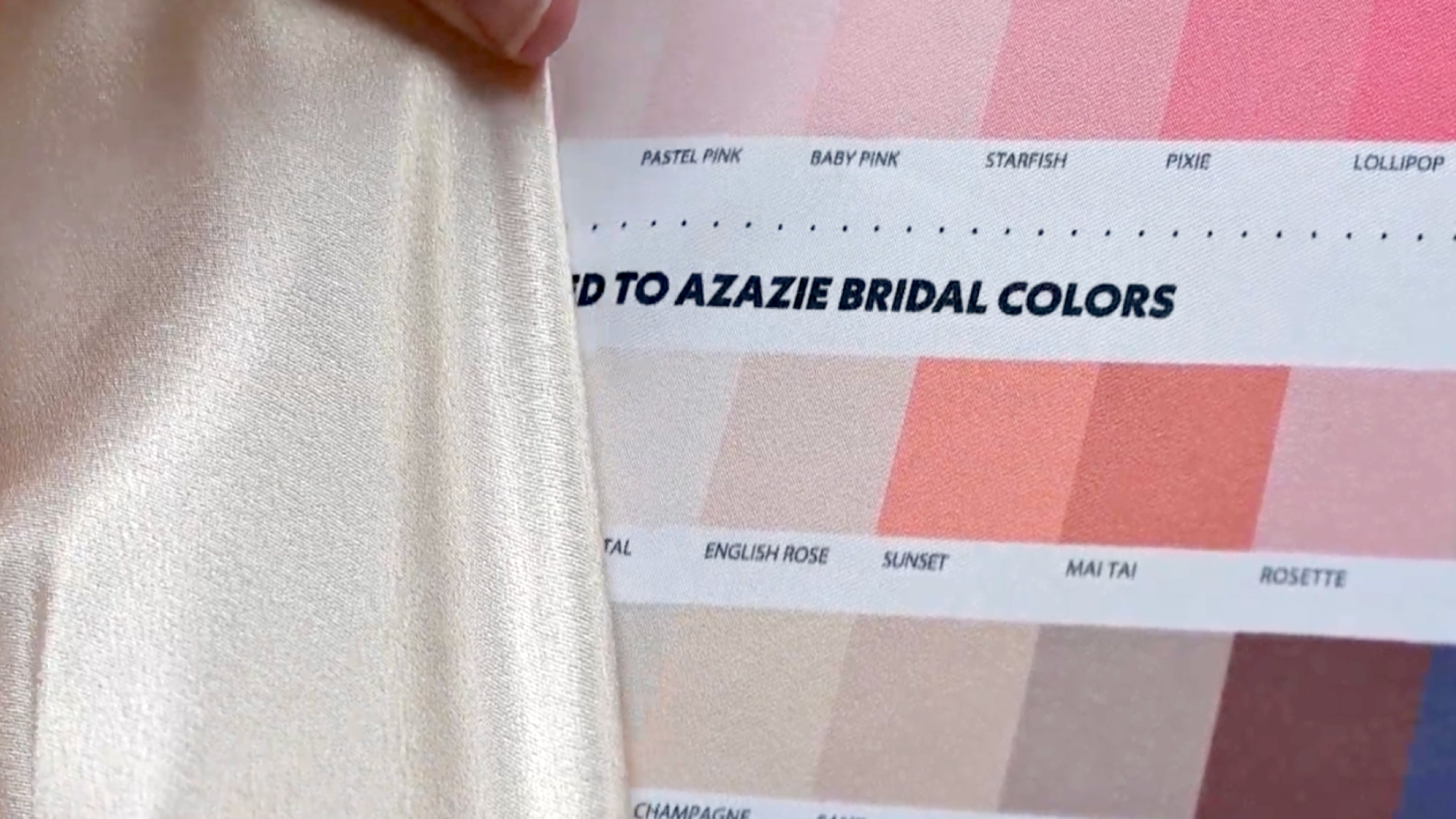hand holding a metallic dress up to the ColorMatch chart