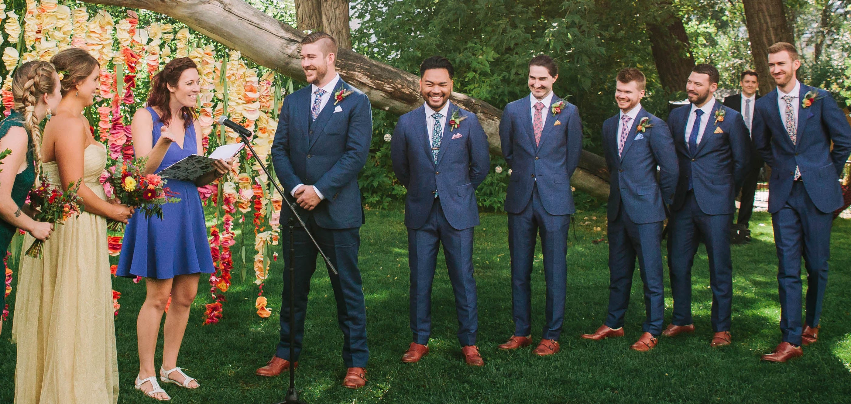 Wedding alter with groomsmen wearing different floral neckties