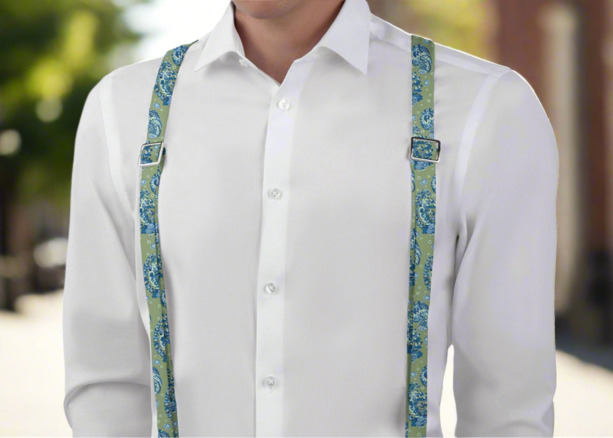 Floral paisley green and blue colored suspenders worn by man with white shirt in an outdoor setting