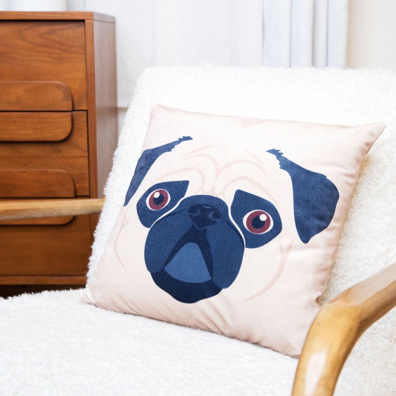 Dog face pillow sitting on a chair