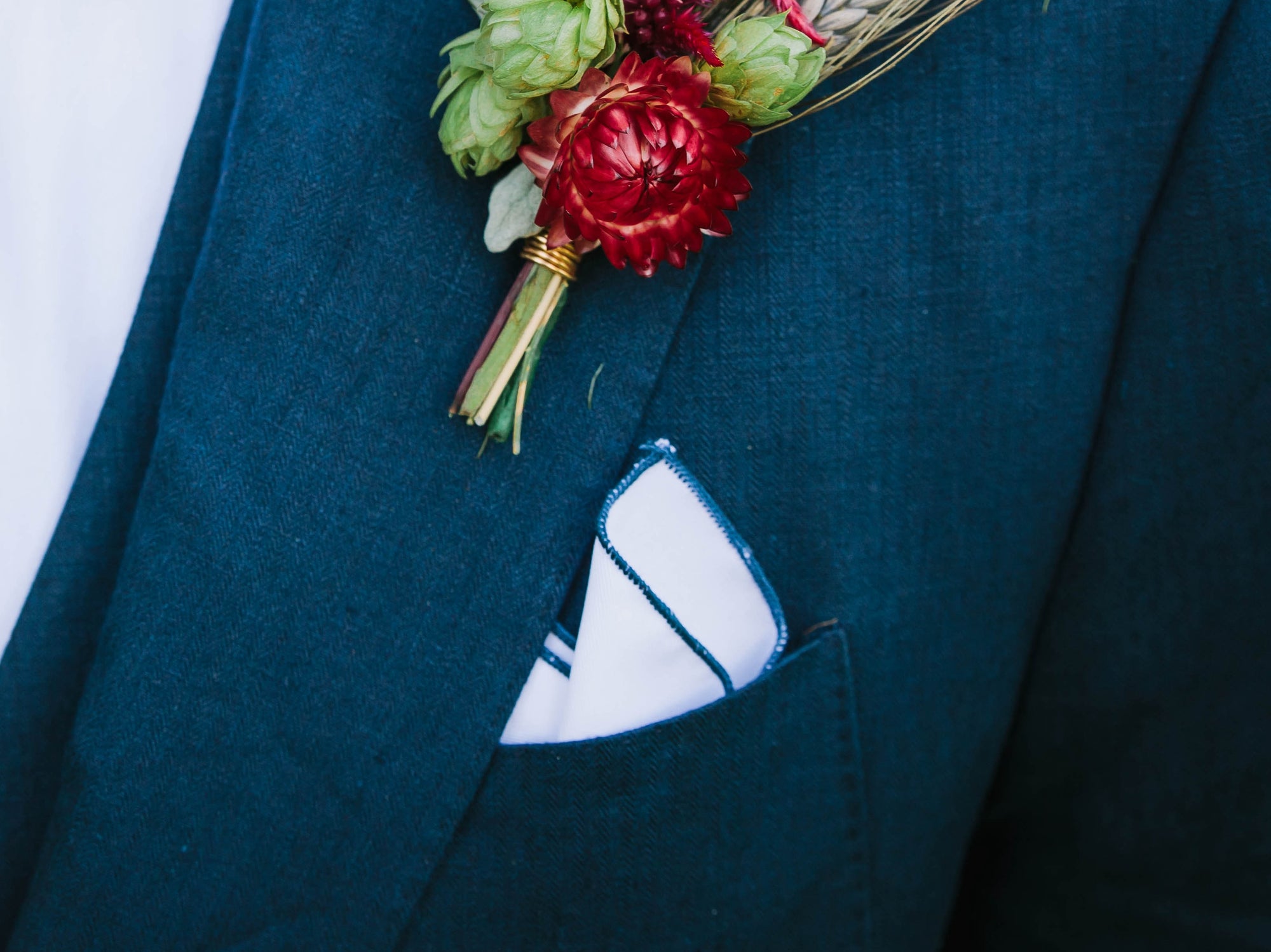 White pocket square with navy edge stitching