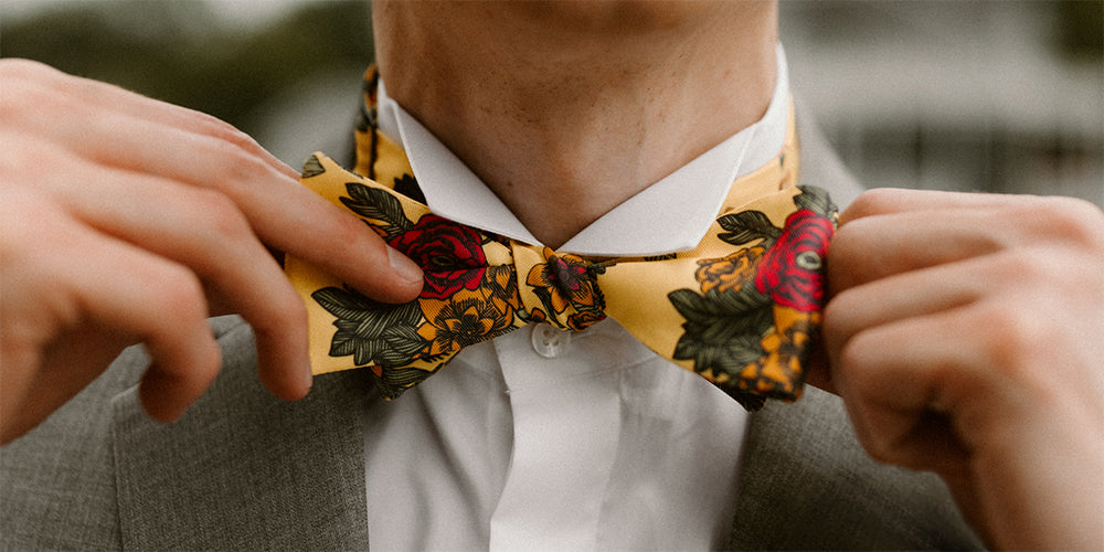 Man tightening his floral bow tie