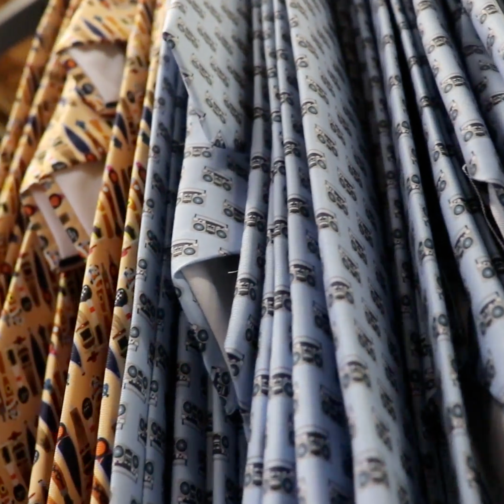 Collection of patterned ties hanging on a rack