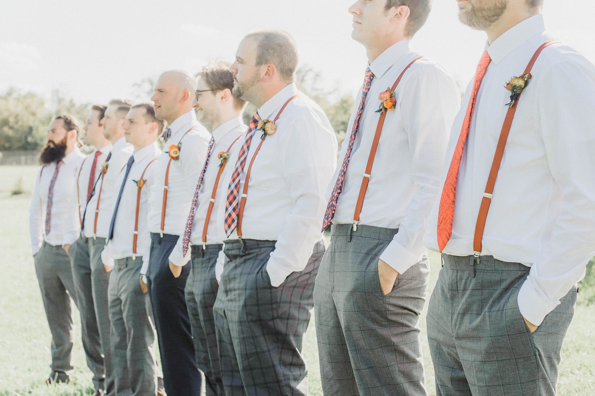 groomsmen ties with mixed patterns in the same colors worn with suspenders