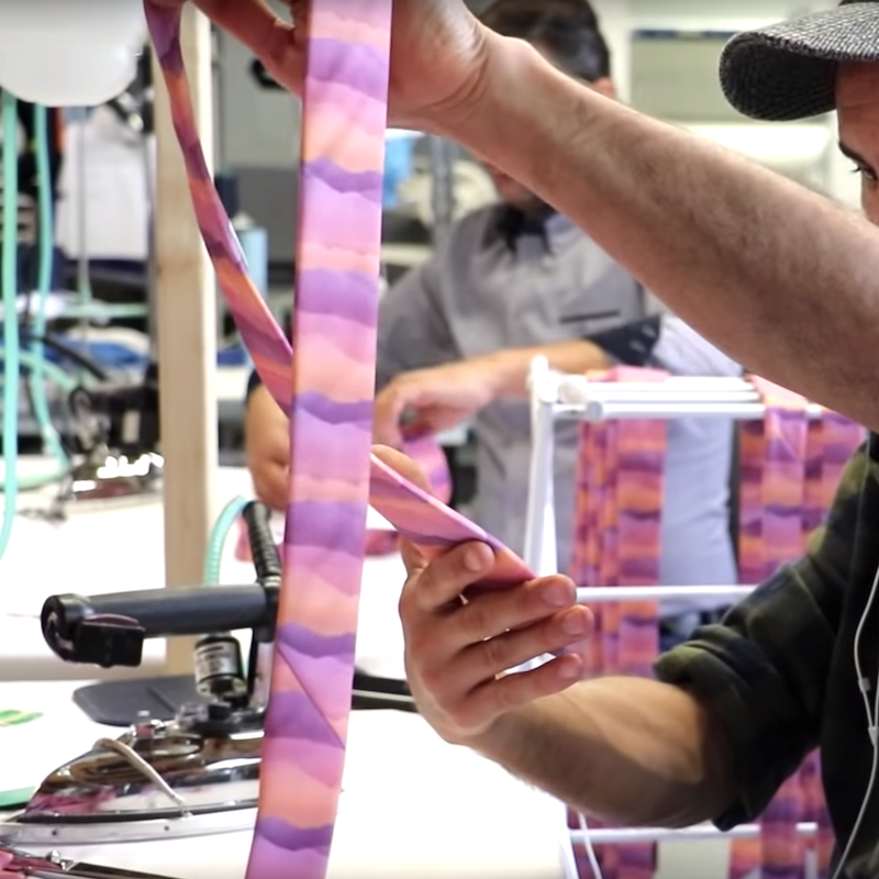 man inspecting a necktie for quality assurance