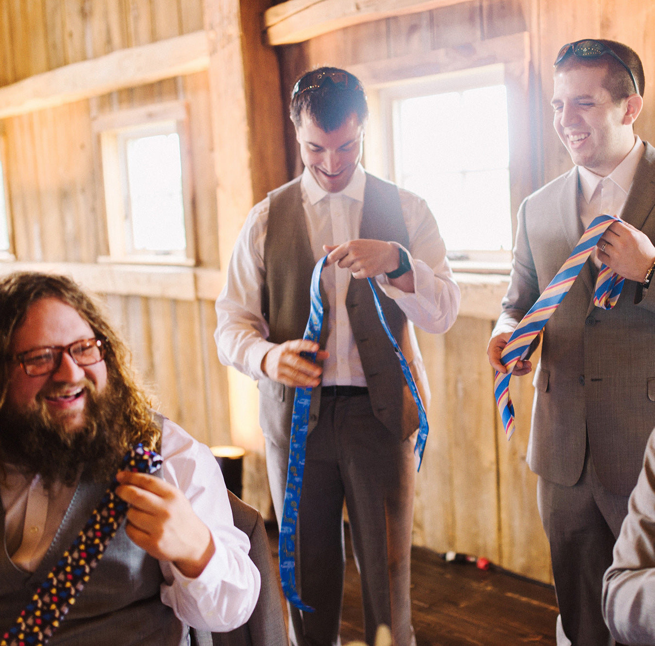Groomsmen opening their customized wedding neckties