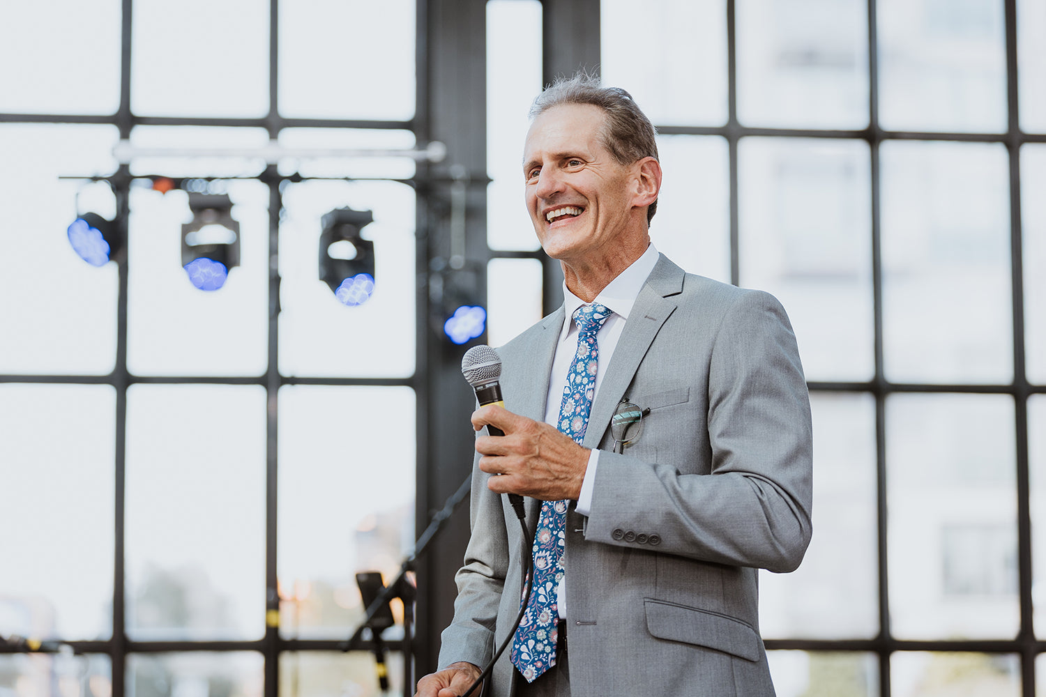 man on a stage wearing a necktie