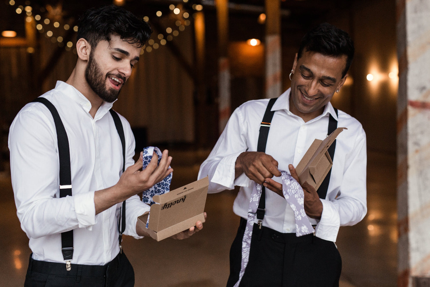 two men opening boxes with bow ties inside