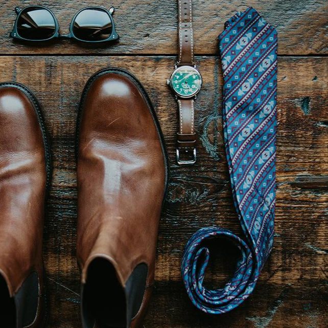 Wedding accessories laid out including customized necktie
