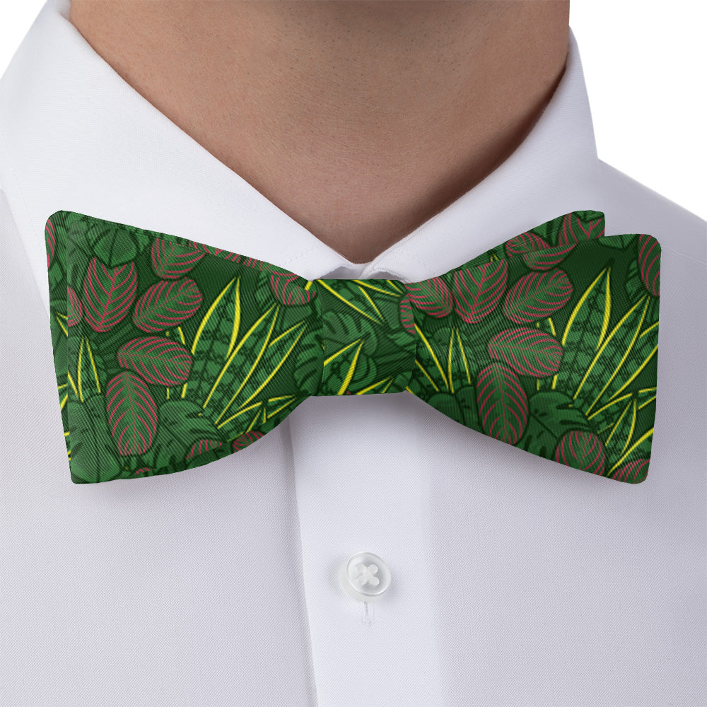 Green houseplant leaf-patterned bow tie worn by a person on a white shirt.
