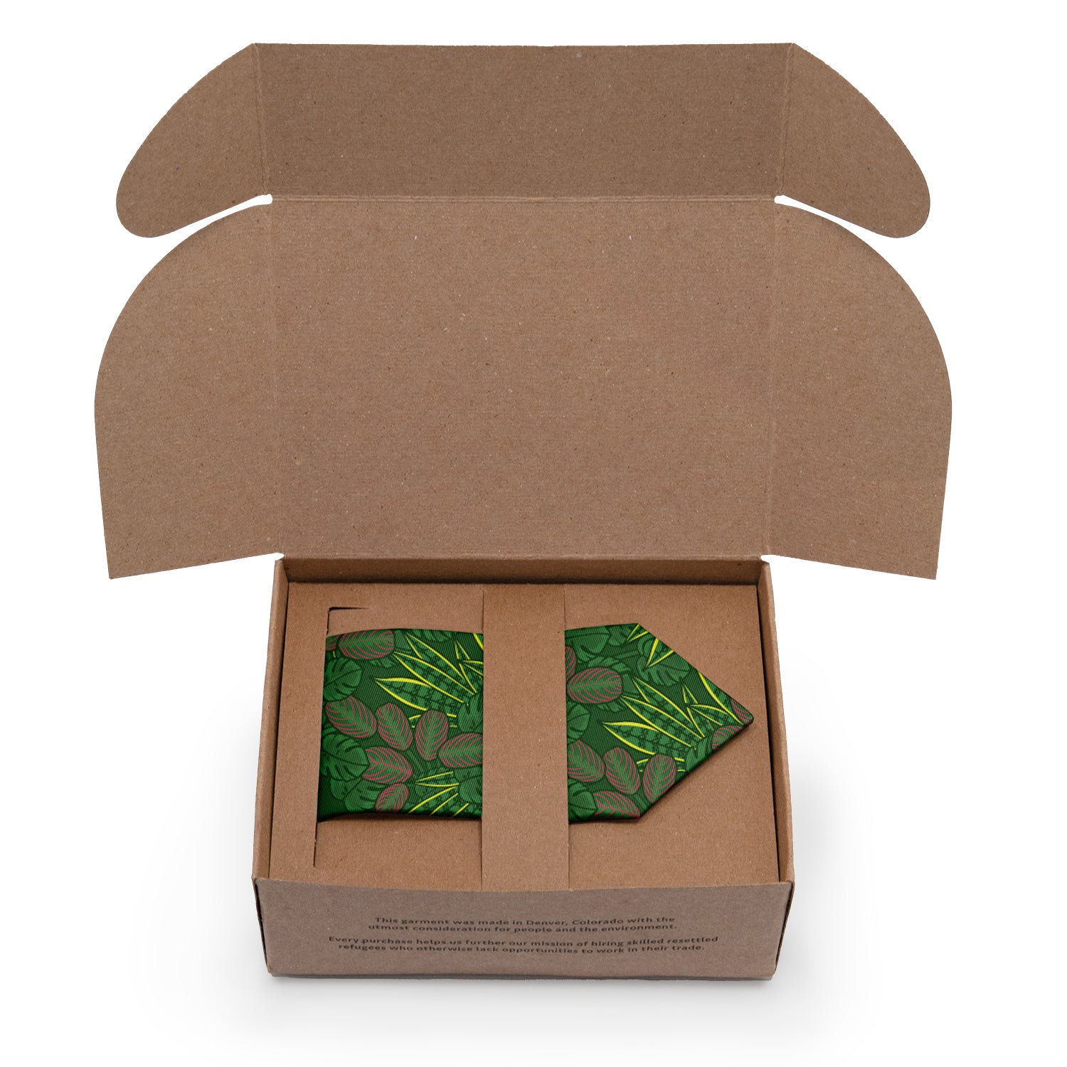 Open cardboard box with a green leaf-patterned tie inside on a white background