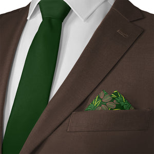 Brown suit with green tie and houseplant pocket square on a white background