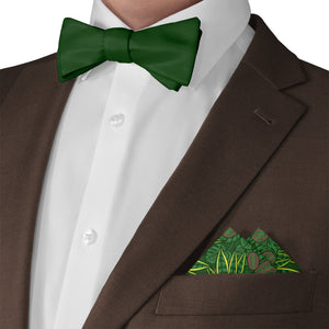Green bow tie and houseplant pocket square with a brown suit on a white background