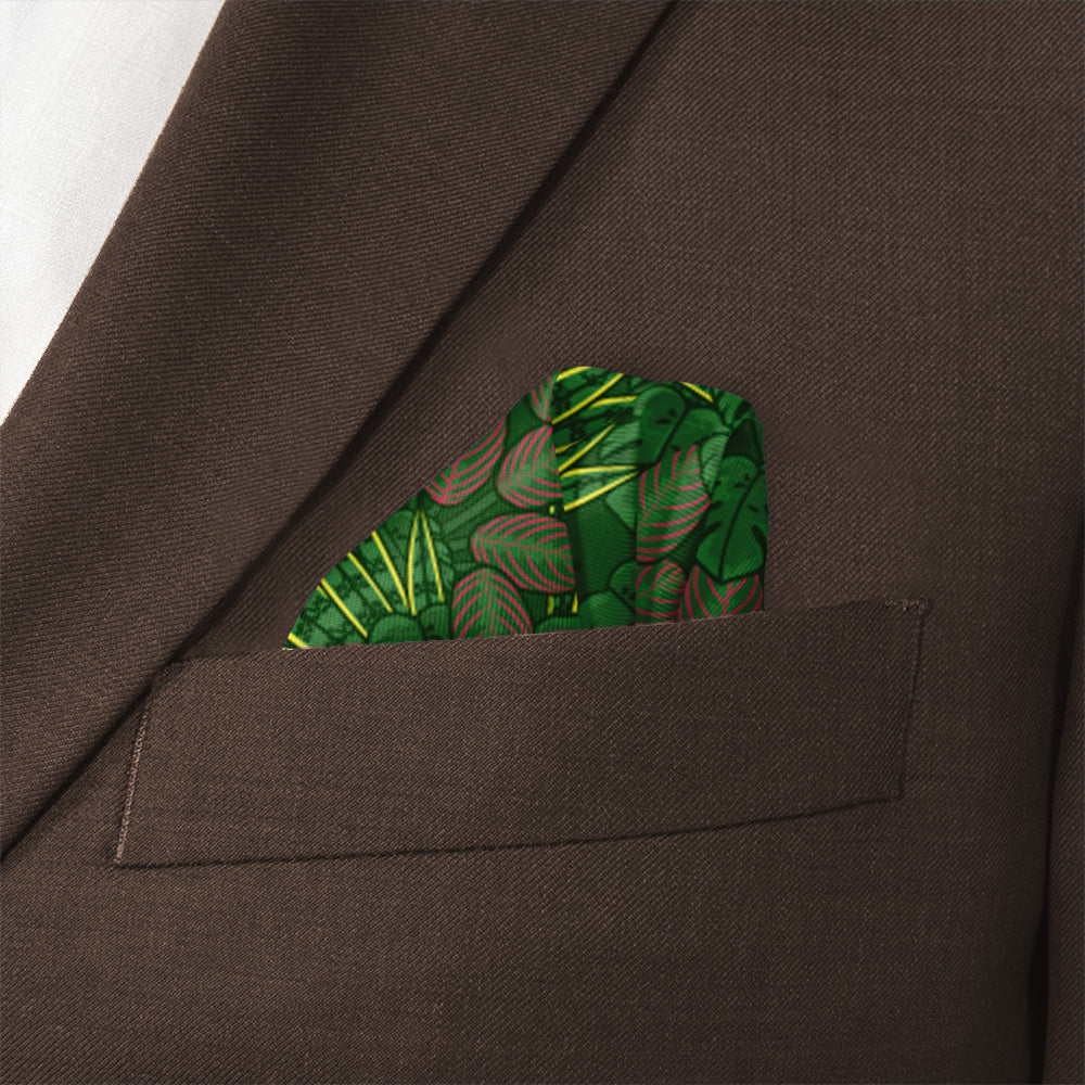 Green houseplant leaf-patterned handkerchief in a brown pocket of a suit jacket.
