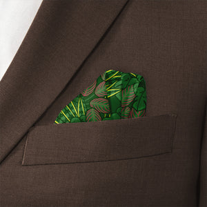 Green houseplant leaf-patterned handkerchief in a brown pocket of a suit jacket.