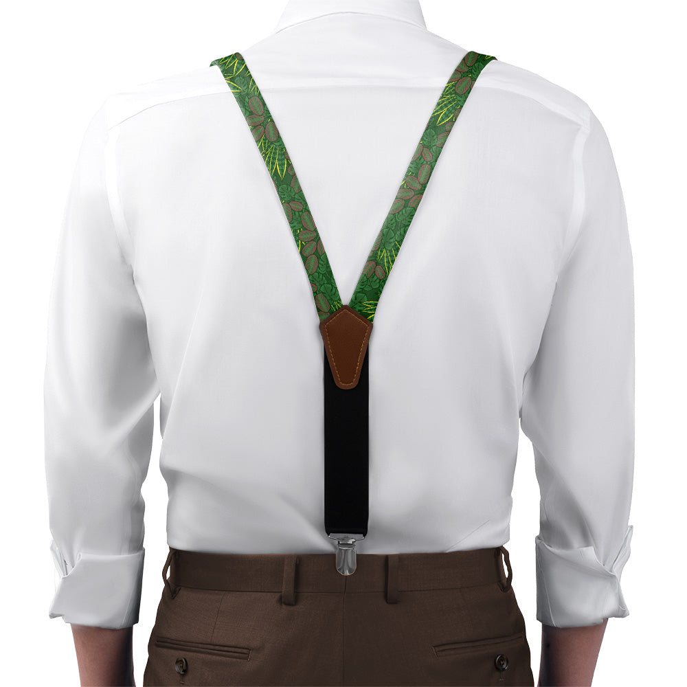 Green patterned suspenders on a white shirt with brown pants