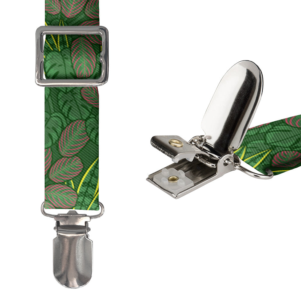 Suspenders with green leaf pattern and metal clips on a white background