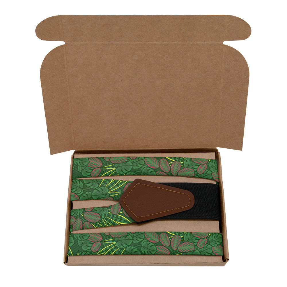 Open cardboard box with a green patterned item and a brown leather tag inside.
