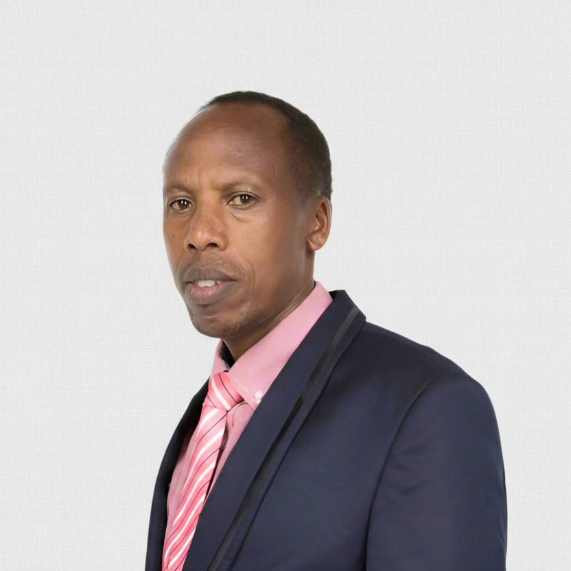 Man wearing a navy blazer and pink shirt with a striped tie on a light gray background