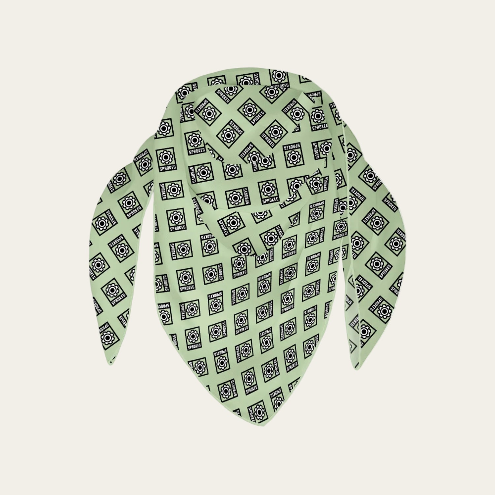 Green scarf with black pattern on a light gray background