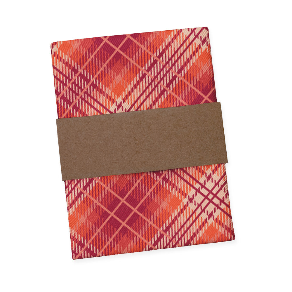 Plaid red and orange pocket square folded with packaging band wrapped around it
