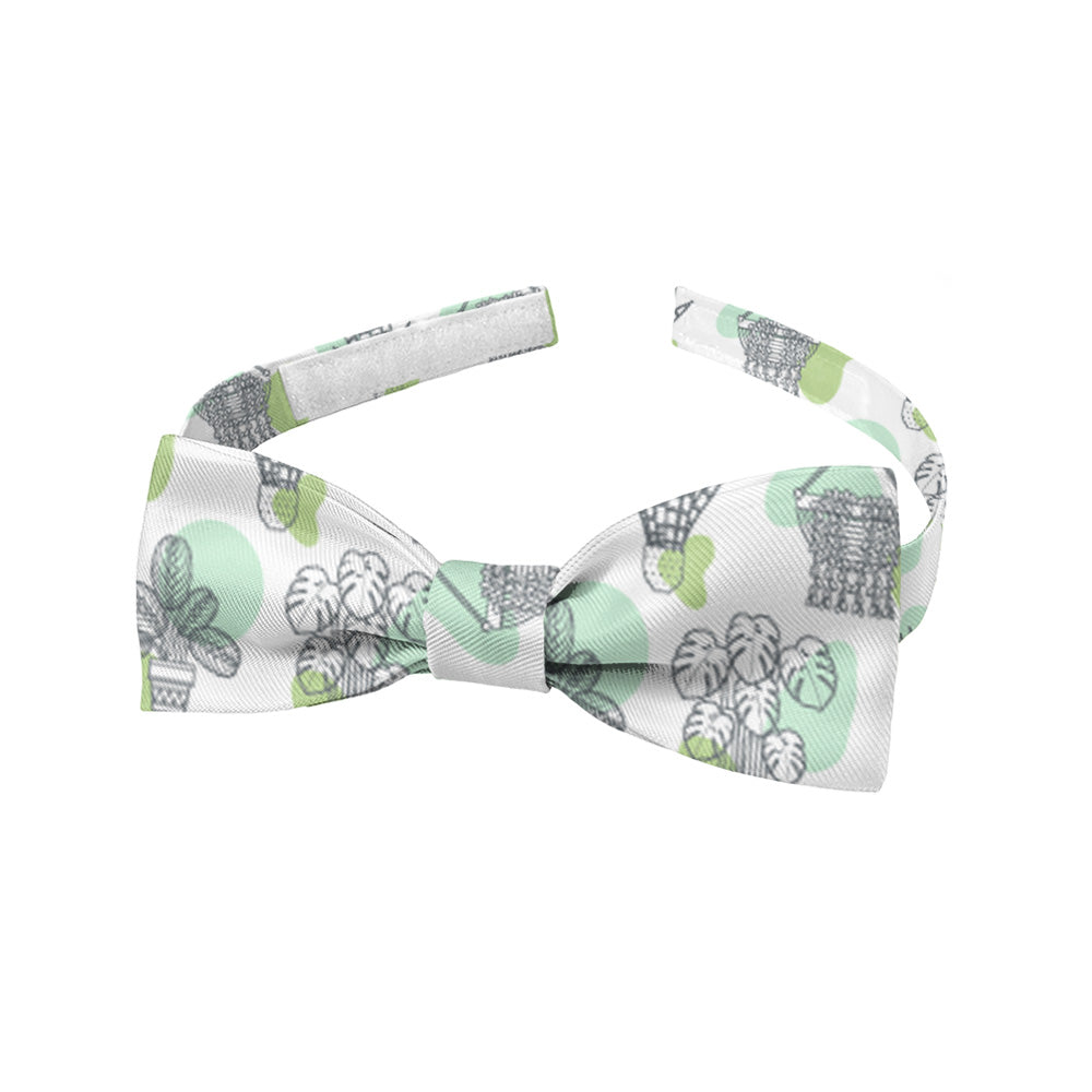 Green and white potted plant patterned baby bow tie on a white background