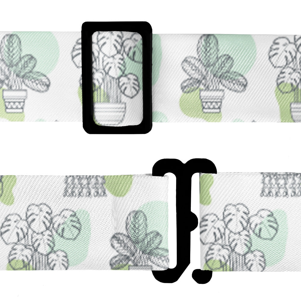 Bow tie strap with potted plant pattern and hardware on a white background