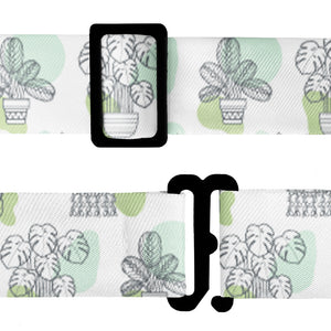 Bow tie strap with potted plant pattern and hardware on a white background