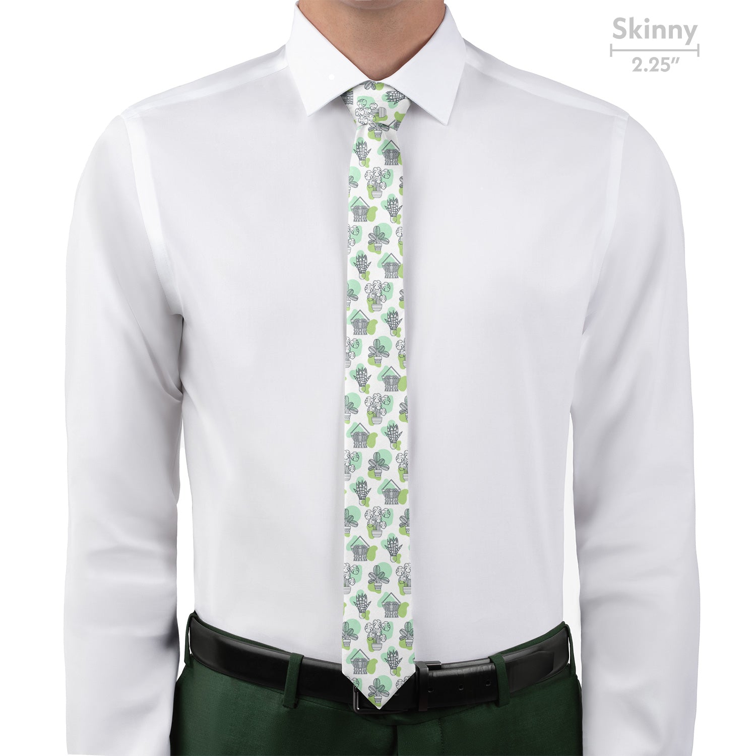 Man wearing a white shirt with a potted plant patterned tie and green pants on a white background