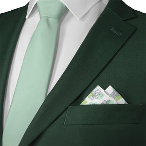 Green suit with a light green tie and matching potted plant pocket square.