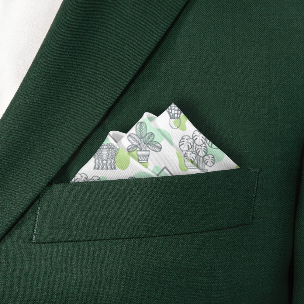 Green suit jacket with a potted plant patterned pocket square featuring plants.