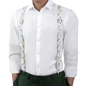 White shirt with green floral suspenders on a white background