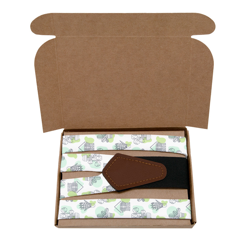 Open cardboard box with a potted plant patterned suspenders inside