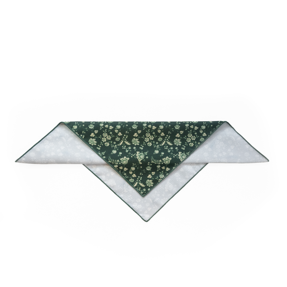 A triangular pocket square showing a dark green front with a small floral pattern.