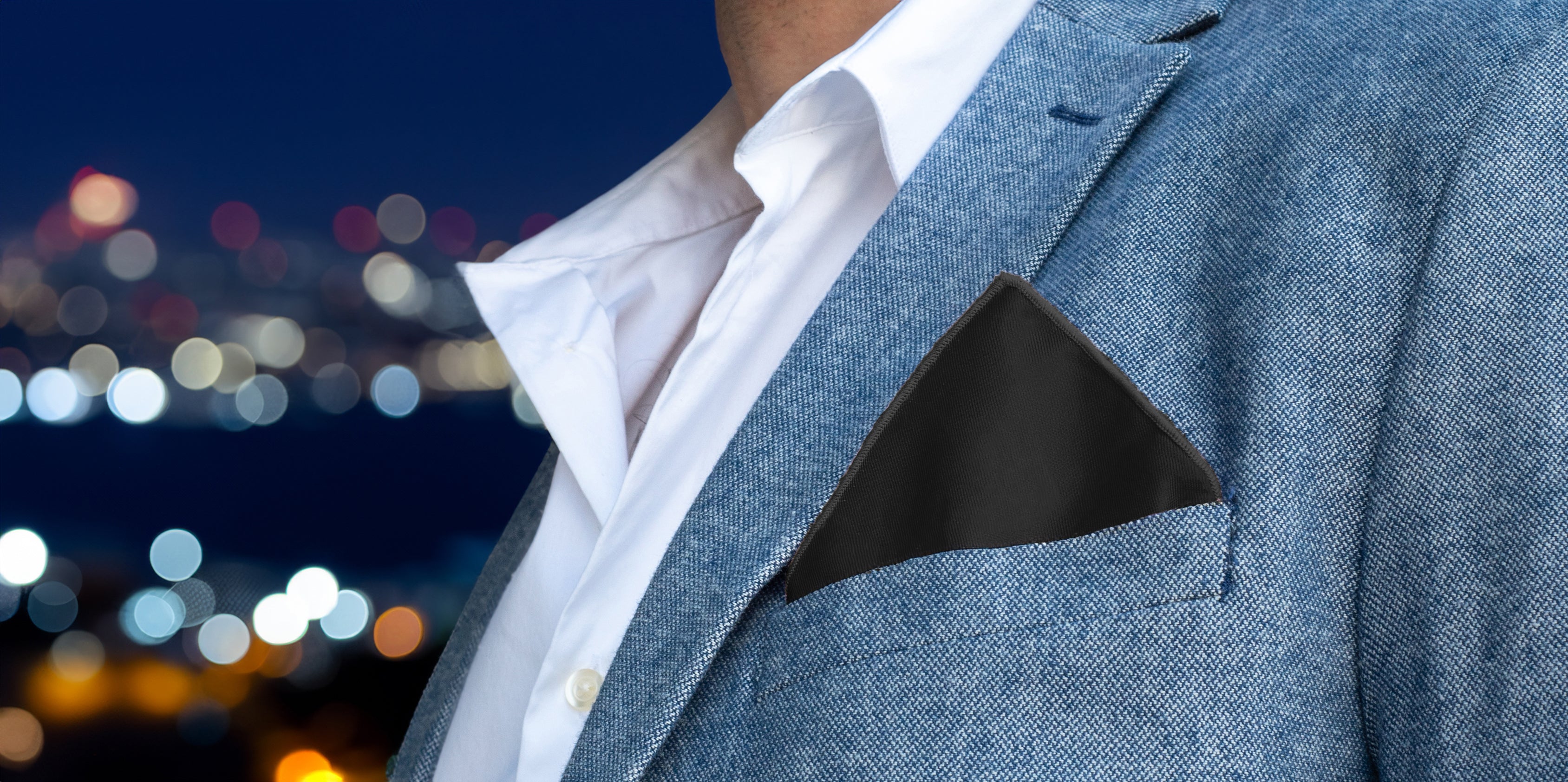 solid black pocket square in blue jacket pocket
