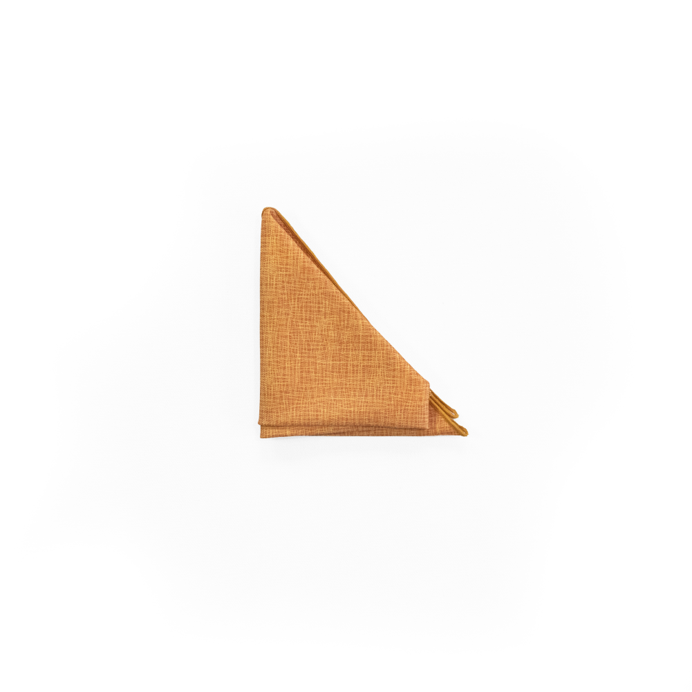 A square pocket square made of twill fabric in a warm tan color in triangle fold.