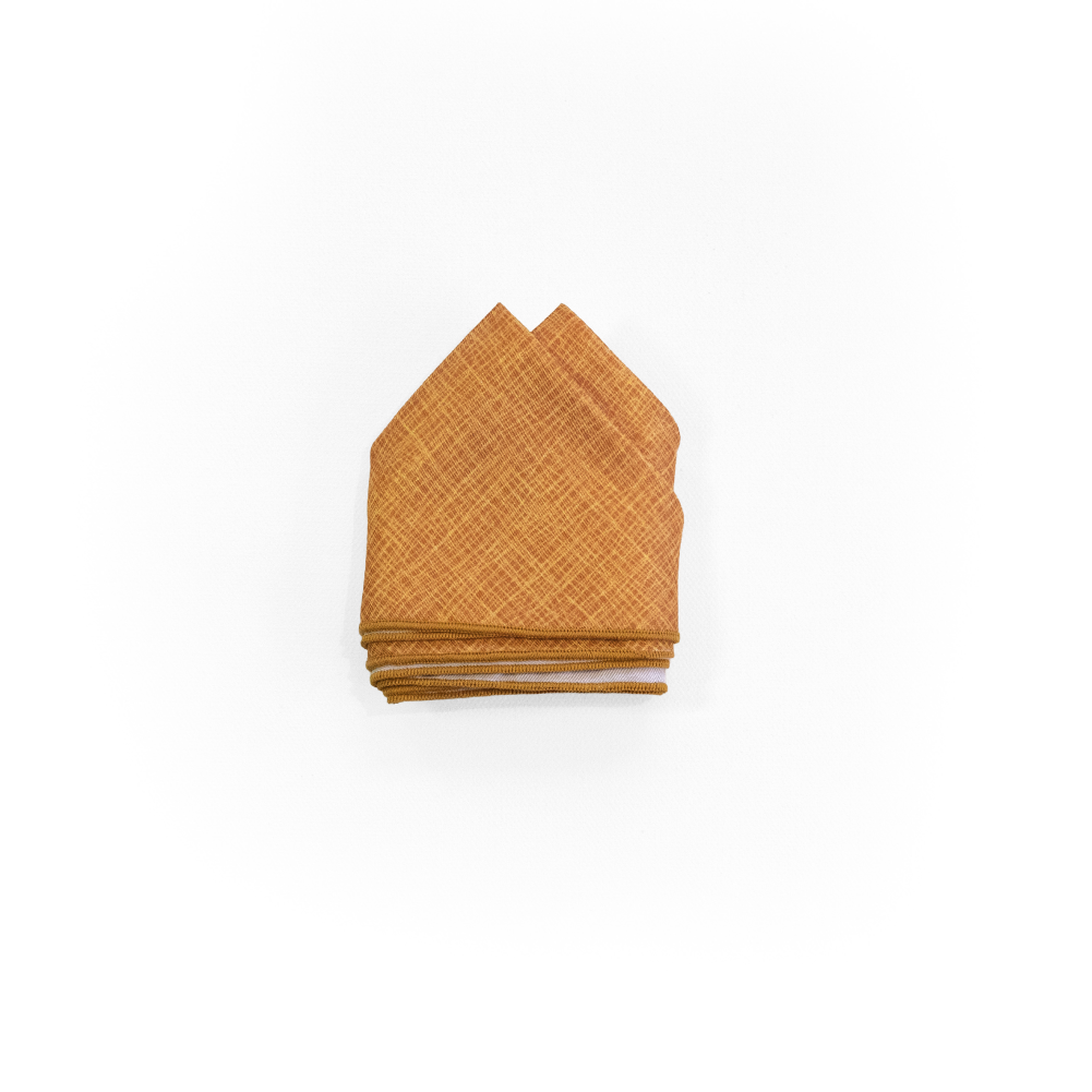 A folded two point pocket square in a warm mustard yellow color with a subtle basketweave pattern.