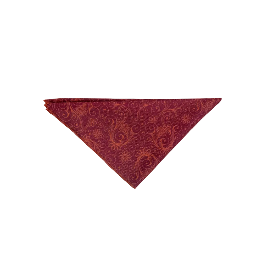 A triangular pocket square in deep burgundy with an rust-orange paisley pattern
