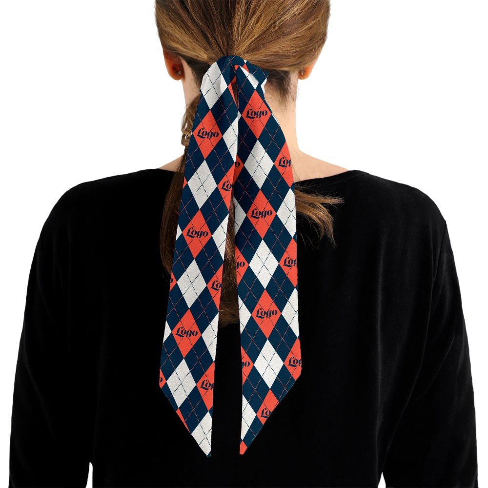 Person wearing a patterned hair scarf around their bun on a white background