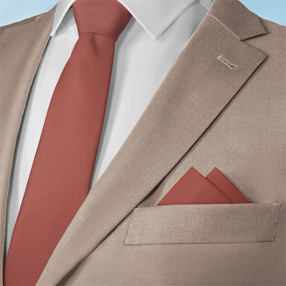 Beige suit with pocket square that matches Azazie bridesmaid dresses on a light blue background
