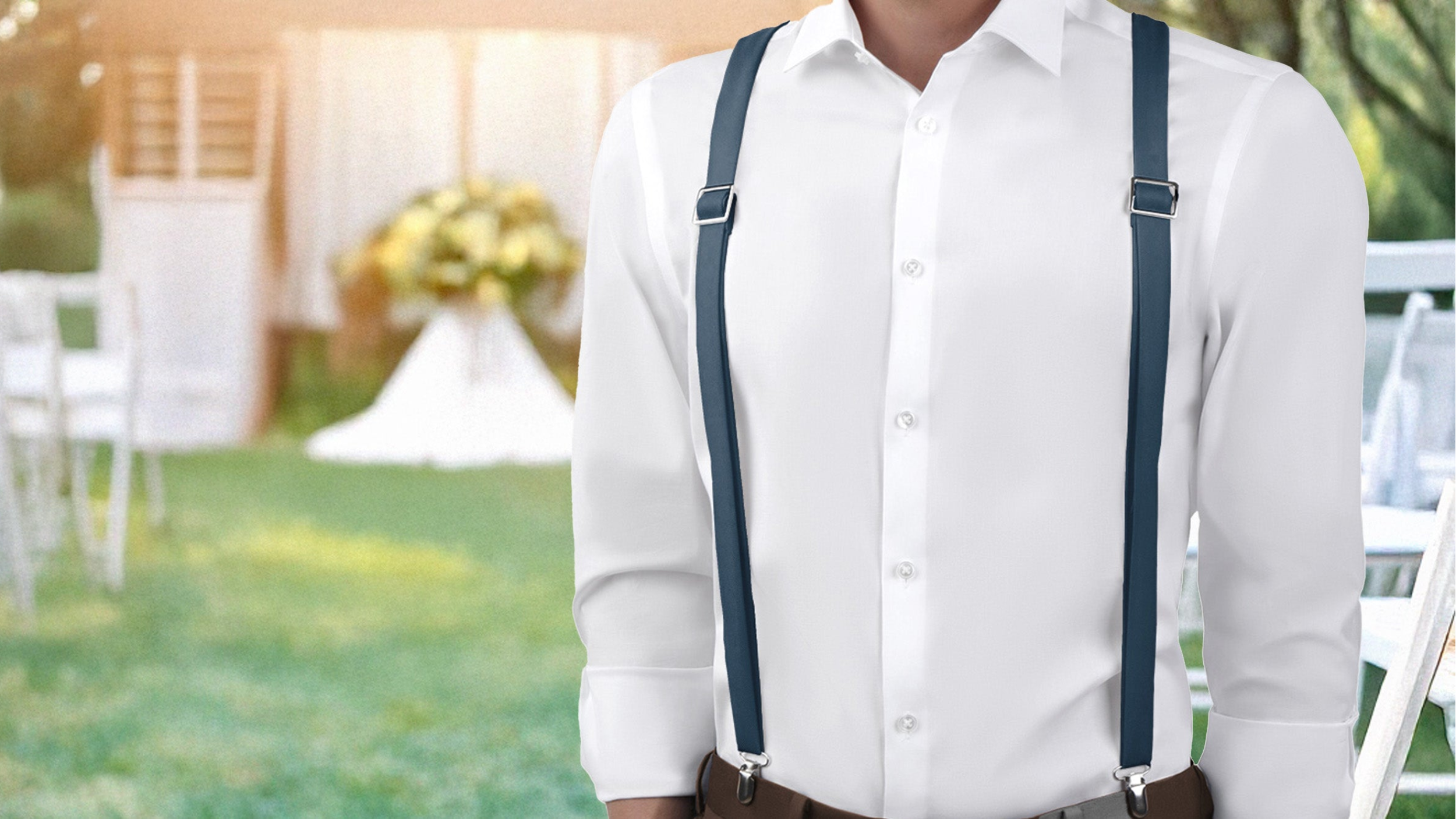Man wearing a white shirt and suspenders matched to Azazie bridesmaid dresses standing outdoors with tables and chairs in the background