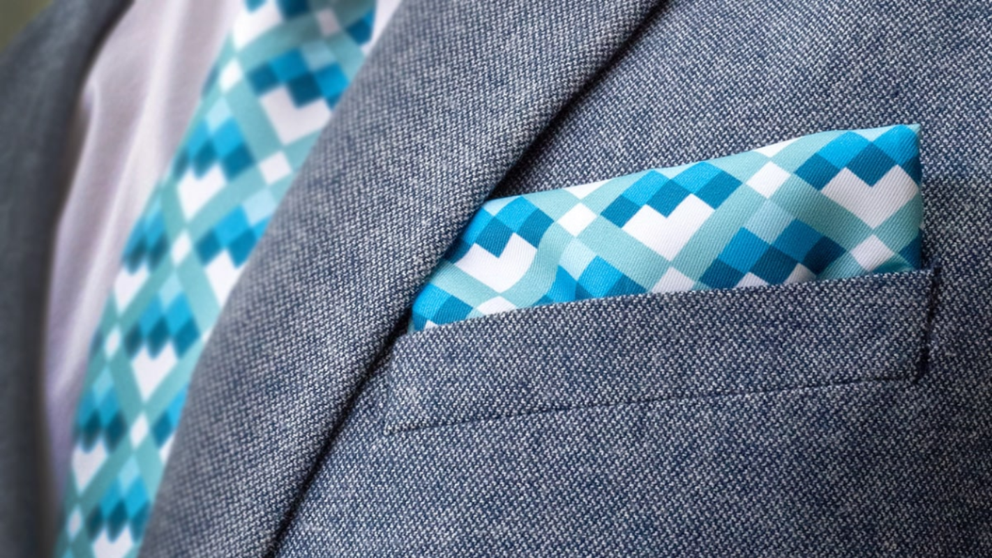 Gray suit jacket with a blue and white patterned pocket square