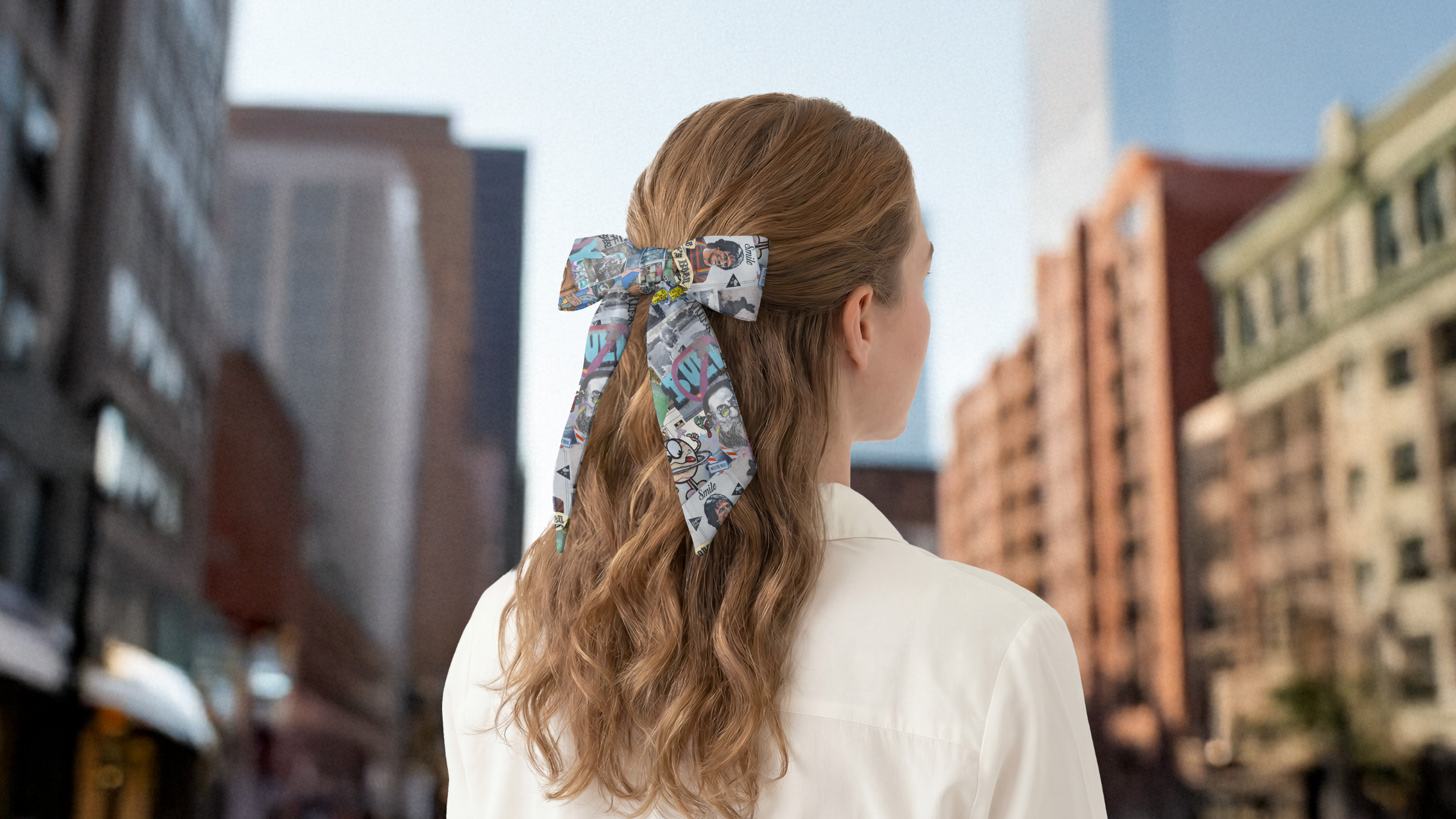 Person with a large hair scarf standing in an urban setting