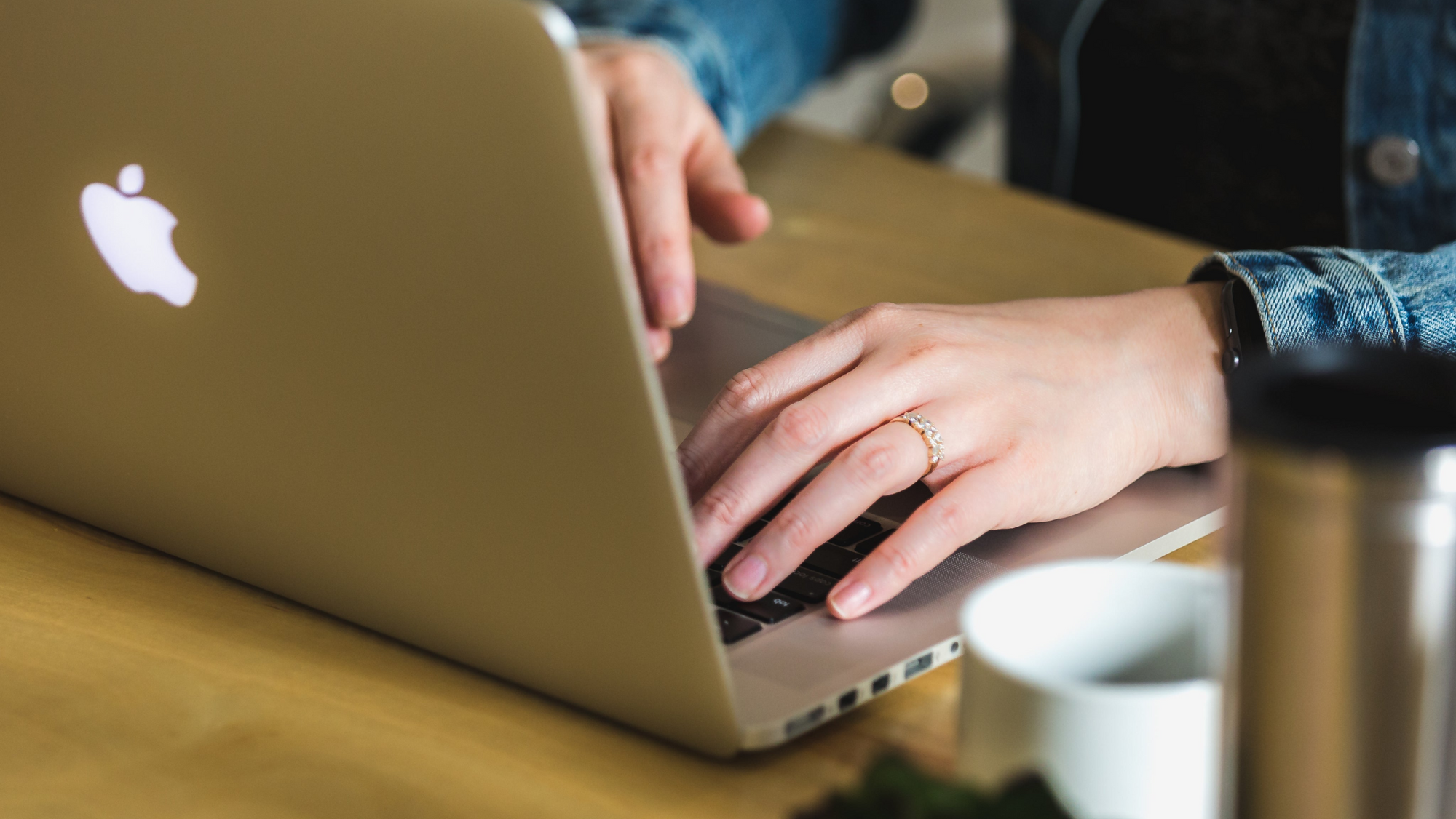 hands typing on a laptop keyboard