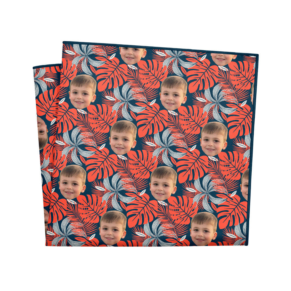 Personalized pocket square with red and gray floral pattern and a boy's face printed repeatedly on a white background.