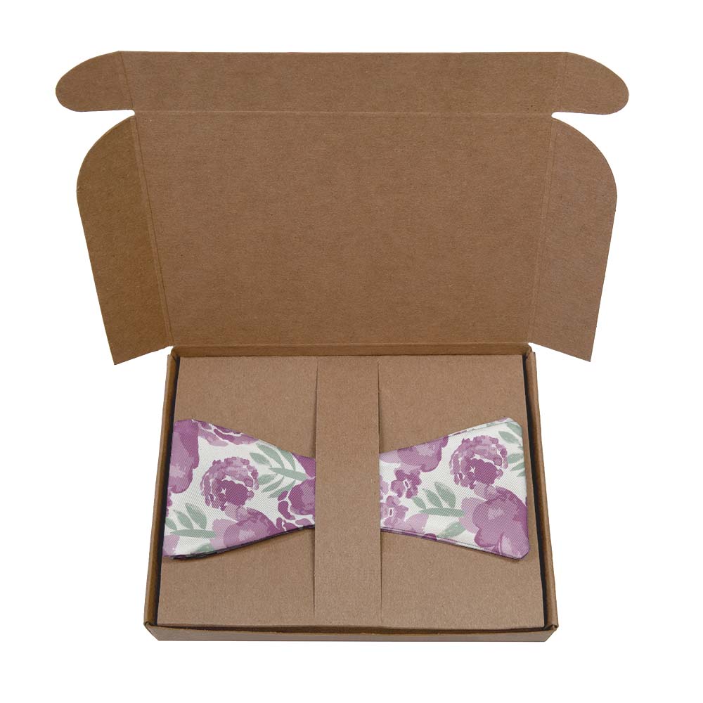 Floral-patterned bow tie in a kraft box on a white background