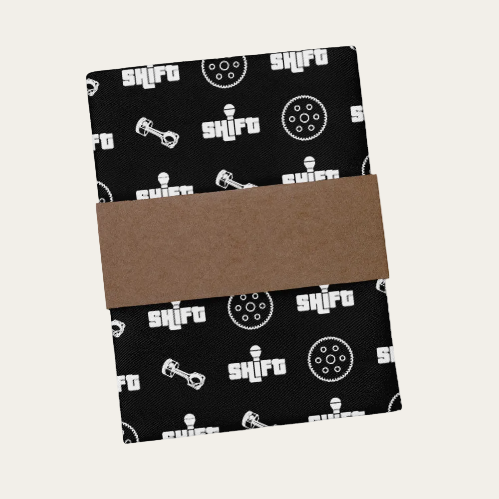 Black fabric with 'Shift' logo and brown cardboard in the center on a white background