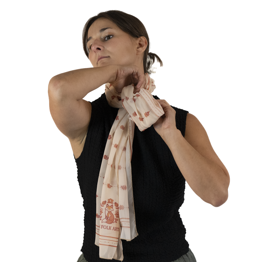 A woman slipping the ends of the scarf  into the knot in her scarf.
