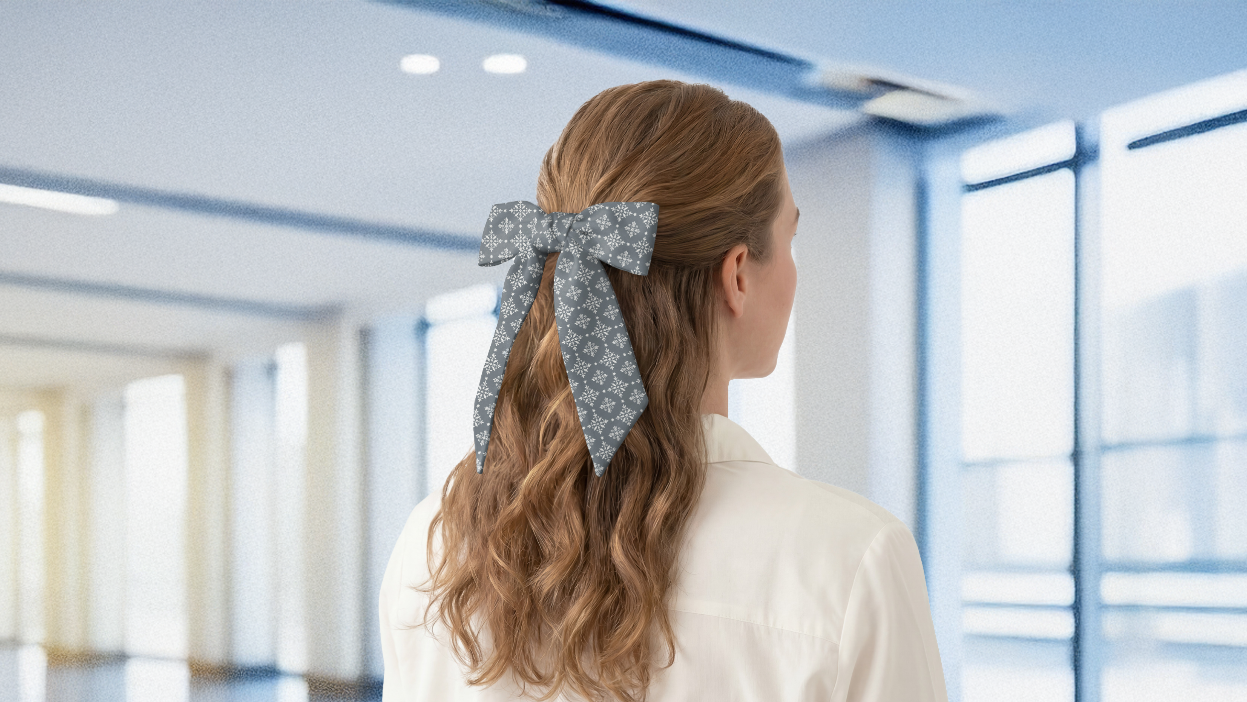 Person with a geometric hair scarf in an office setting
