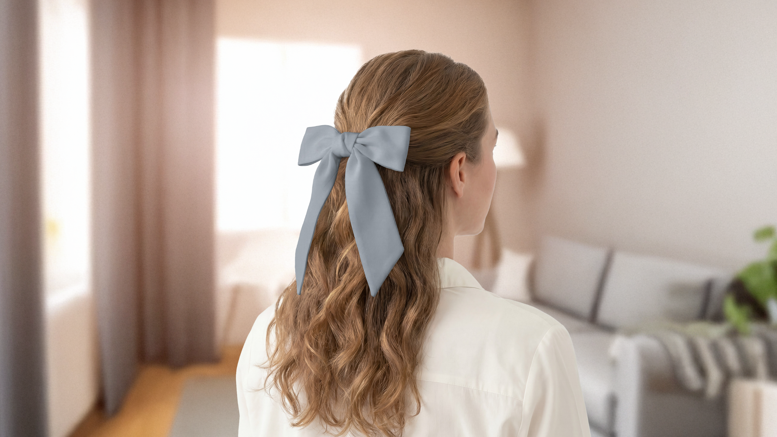 Person with a gray scarf in their hair standing in a living room.